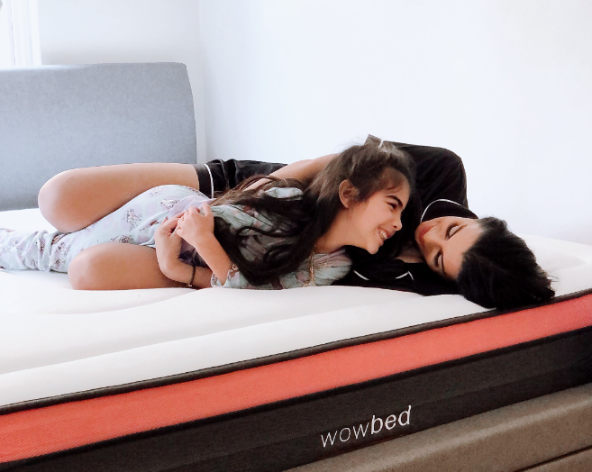 mother and daughter playing on mattress