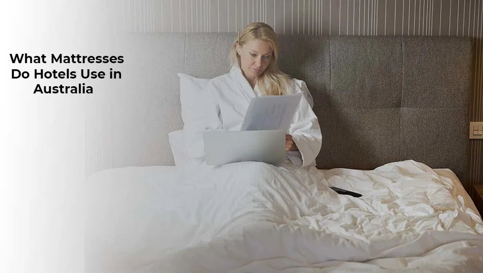 A woman sitting comfortably on a high-quality hotel bed with a white duvet, illustrating the types of mattresses used in Australian luxury hotels.