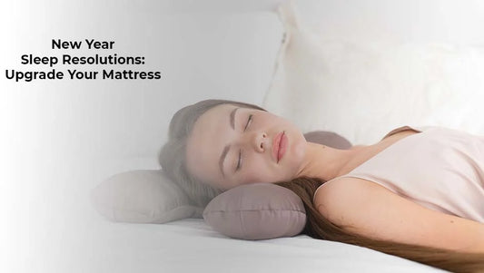 Furniture consultant assisting a couple on a grey sofa during a 2026 New Year furniture sale event.