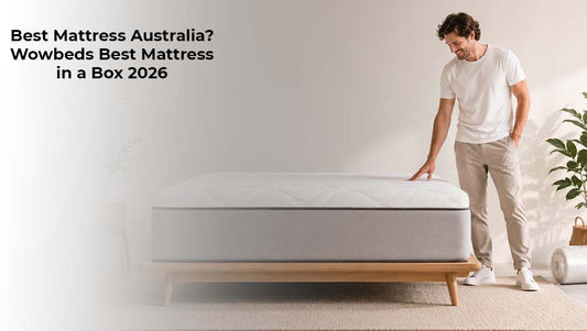 Man standing beside a modern mattress in a bright bedroom showcasing Wowbeds mattress in a box