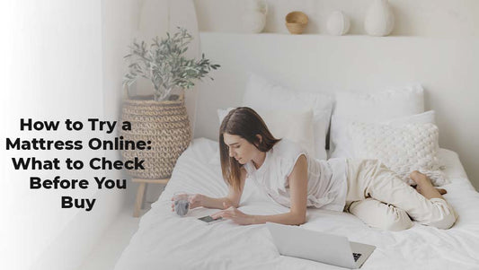 Woman lying comfortably on a white mattress using a laptop and phone, illustrating how to check a mattress online before buying.