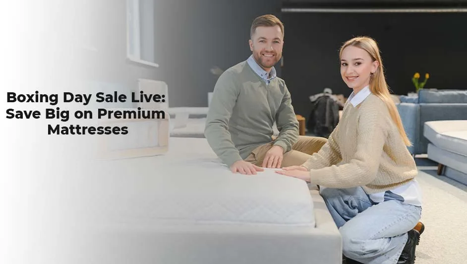 A young couple shopping for a premium hybrid mattress during a Boxing Day sale at a furniture store