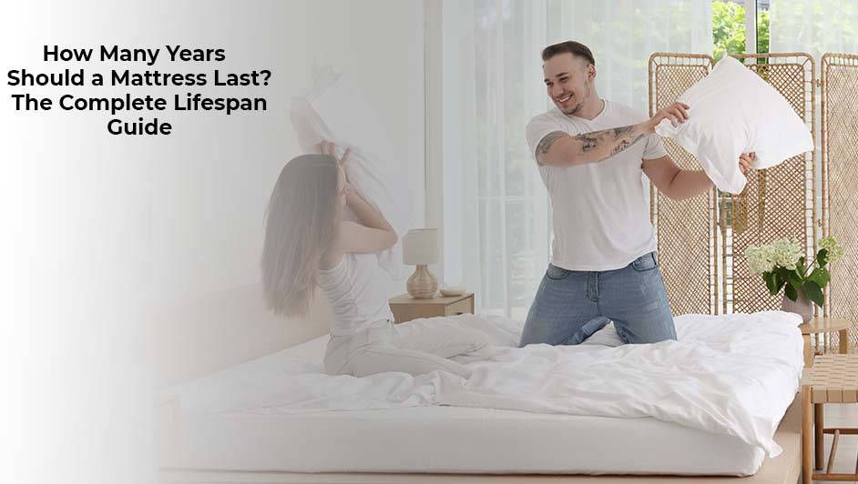 couple playfully fighting with pillows on bed showing mattress comfort and durability